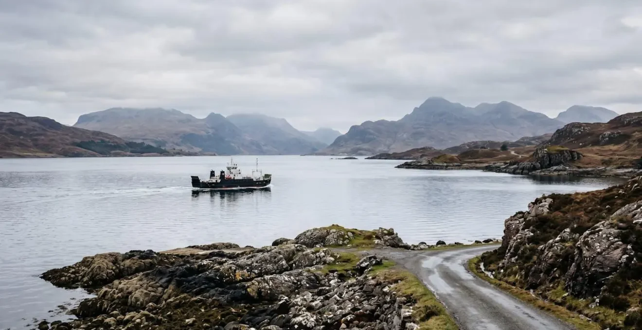 Dramatic coastal landscape with ferry vessel on open water representing journey infrastructure